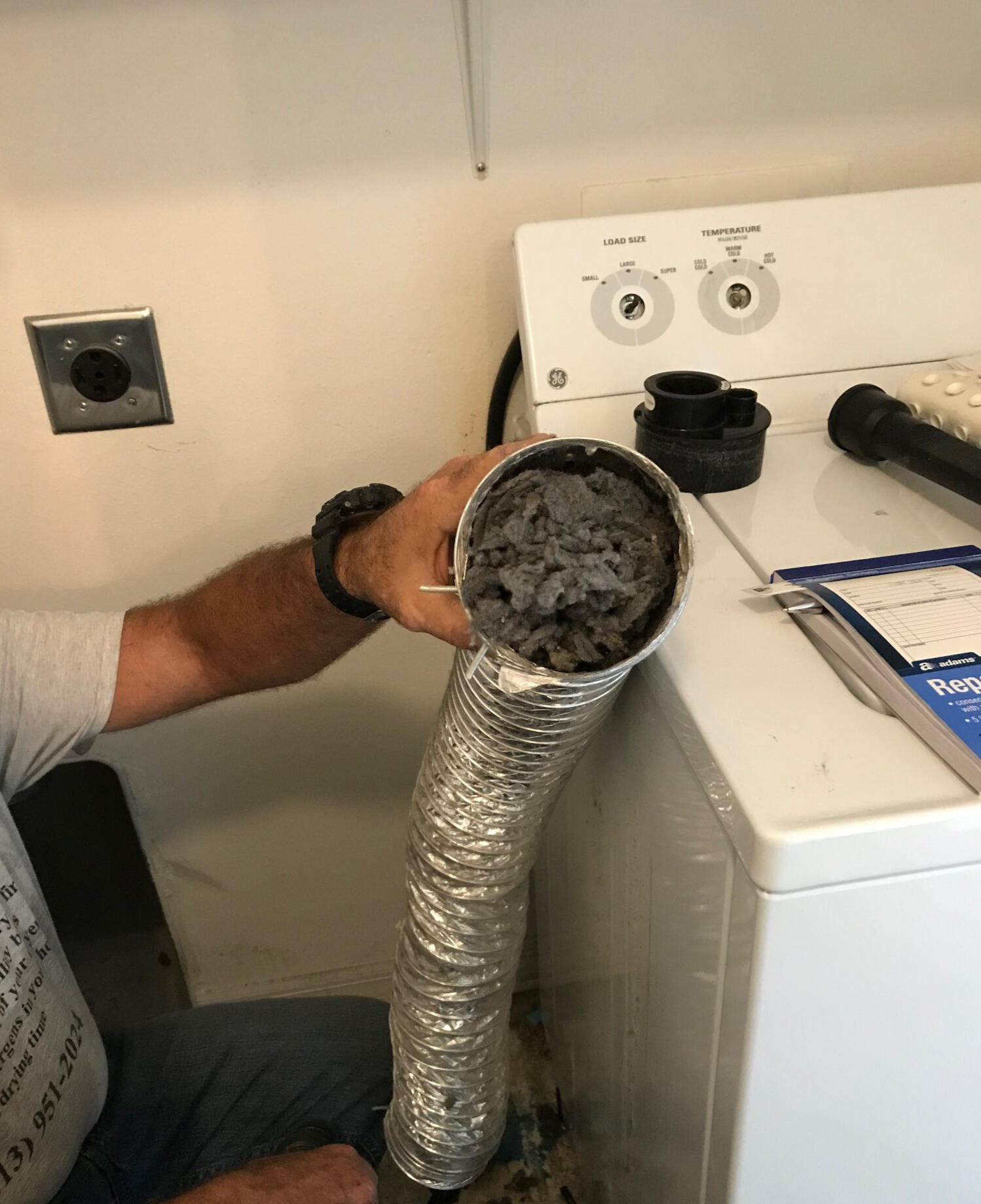 Disconnecting airduct from dryer, pipe full of dirty grey lint